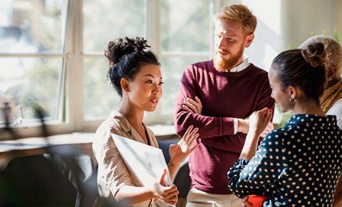 woman presenting an idea to her colleagues